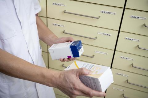 Pharmacist choosing between two medications